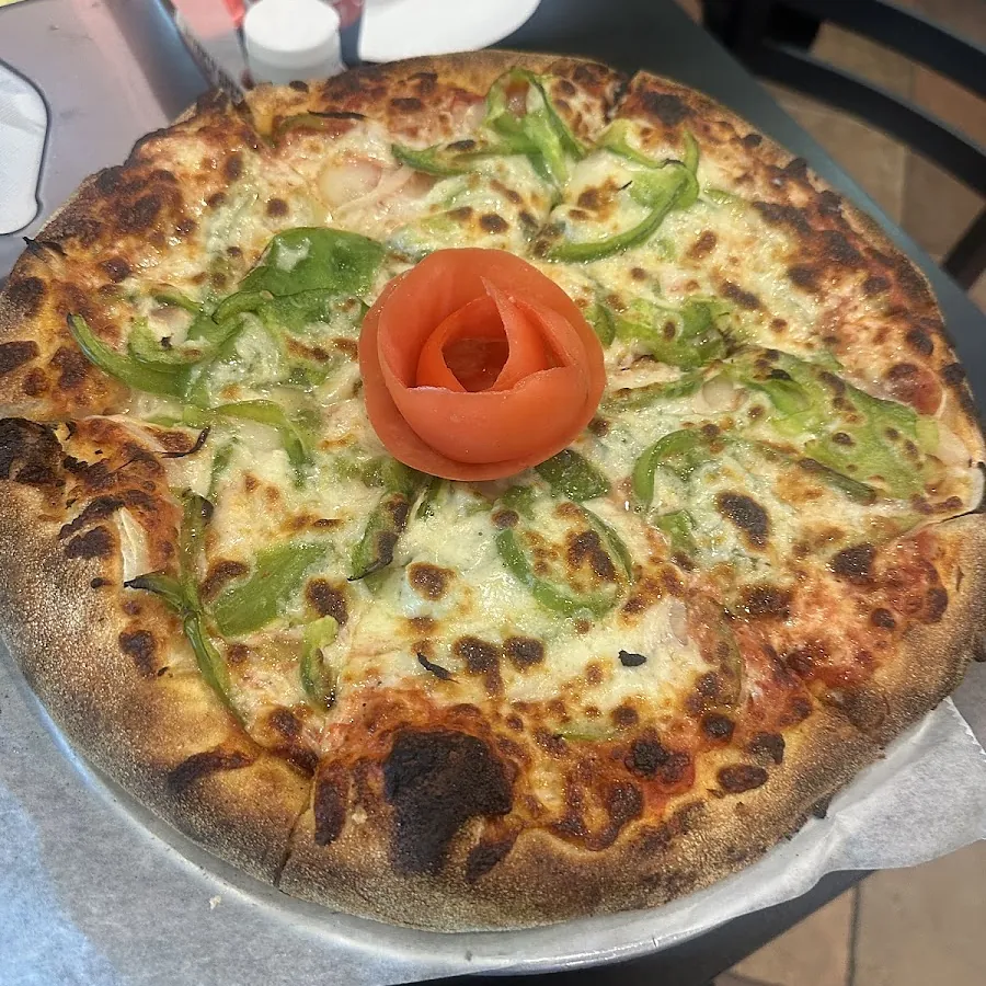 Fresh pizza out of the oven on the pan